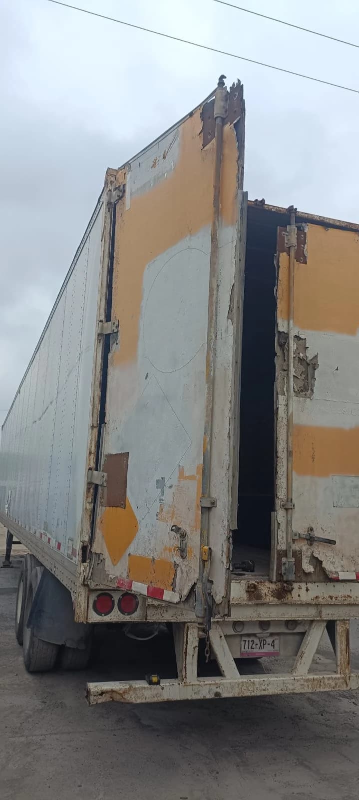 Fotografía original de puertas de caja seca con daño visible